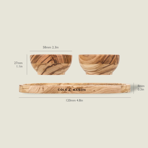 The Cole & Mason Portobello Olive Wood Pinch Pot Set includes two 58mm x 27mm bowls and a 120mm x 8mm tray. Each features unique grain patterns, making every piece distinct. All measurements are labeled.
