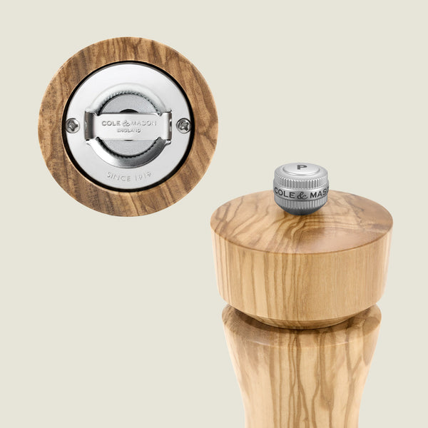 #salt&pepperset The Cole & Mason Portobello Olive Wood Salt & Pepper Mill features a precision metal grinder and a top metal knob labeled "P" with the brand name.