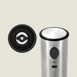 The Cole & Mason Battersea USB Electric Salt & Pepper Mill stands upright on the right, while a close-up of its ceramic grinding mechanism appears on the left, both set against a plain light background.