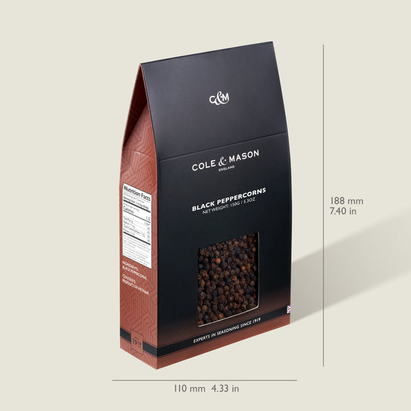 The Cole & Mason Black Peppercorns Box (125g) stands upright with a black and red design, a clear window to display the fresh seasoning, and measures 188mm tall by 110mm wide—ideal for refilling pepper mills.
