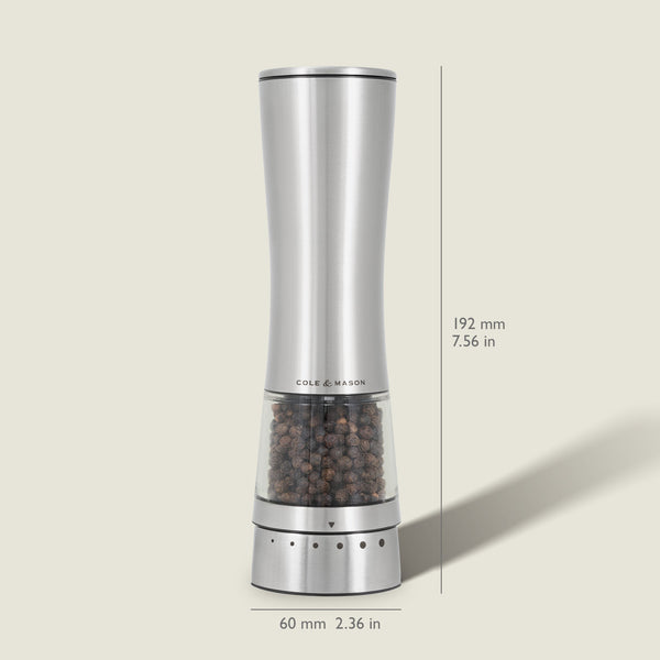 The Cole & Mason Electric Derwent Pepper Mill features a tall, silver design with a transparent lower section filled with peppercorns, measuring 192 mm (7.56 in) high and 60 mm (2.36 in) wide.