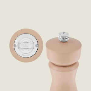 A beige Kenton Salt & Pepper Mill in Himalayan Salt by Cole & Mason is shown upright on the right, with a close-up of its durable ceramic grinding mechanism and branding displayed on the left.