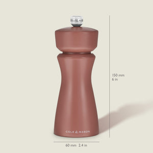 A Cole & Mason Kenton Salt & Pepper Mill in Cinnamon stands upright, measuring 150 mm (6 in) tall and 60 mm (2.4 in) wide, with a curved design and a knob on top. Featuring a durable ceramic grinder, this elegant mill makes a stylish addition to your collection of kitchen accessories.