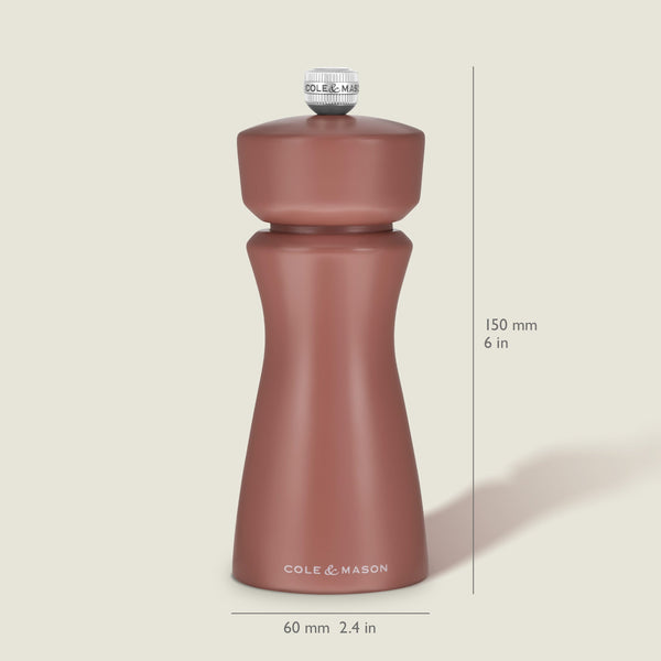 A Cole & Mason Kenton Salt & Pepper Mill in Cinnamon stands upright, measuring 150 mm (6 in) tall and 60 mm (2.4 in) wide, with a curved design and a knob on top. Featuring a durable ceramic grinder, this elegant mill makes a stylish addition to your collection of kitchen accessories.