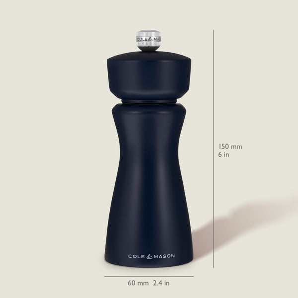 A Persian Blue Cole & Mason Kenton Salt & Pepper Mill stands upright, featuring a durable ceramic grinder for consistent performance. Text indicates its height is 150 mm (6 in) and its width is 60 mm (2.4 in). The light beige background accentuates the classic design of this salt and pepper mill.