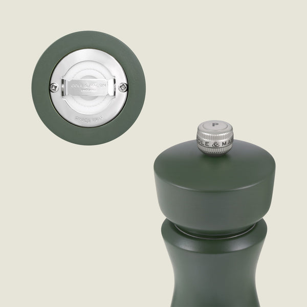 The Cole & Mason Kenton Rosemary Salt & Pepper Mill features a sage green finish, a side and bottom view of its silver grinding mechanism, and a metal knob labeled “P.” Both its base and knob display the Cole & Mason brand name.