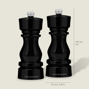 The Cole & Mason London Black Acrylic Salt & Pepper Mills (150mm) feature premium grinding technology and a glossy finish, standing 150 mm tall and 57 mm wide, shown side by side on a neutral background.