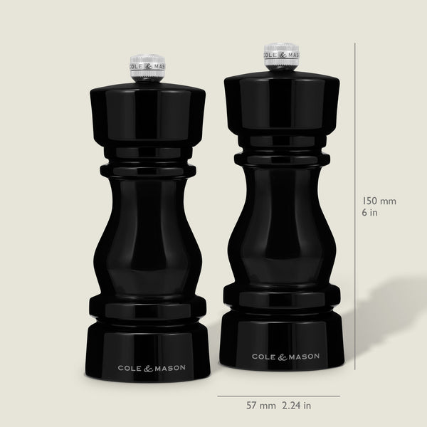 The Cole & Mason London Black Acrylic Salt & Pepper Mills (150mm) feature premium grinding technology and a glossy finish, standing 150 mm tall and 57 mm wide, shown side by side on a neutral background.