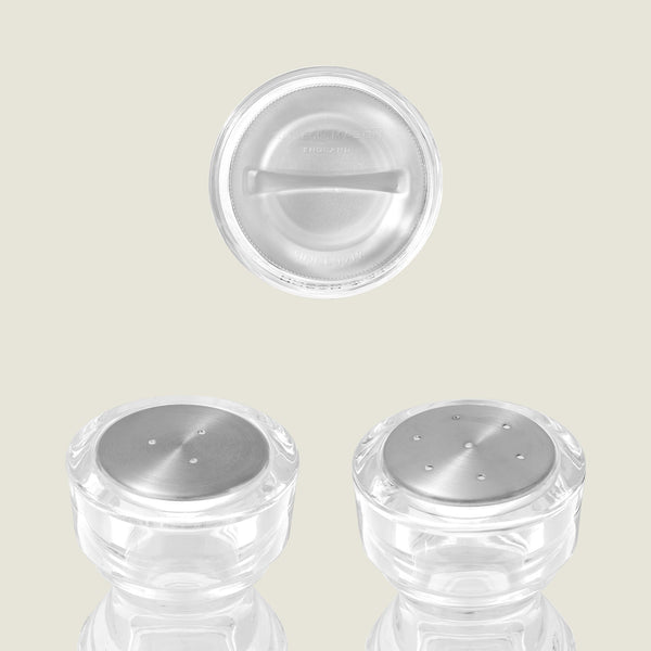 #130mm #shakerset Three Cole & Mason London Acrylic Salt & Pepper Shakers are shown—two side by side on a reflective surface and one from above, spotlighting its circular top—a perfect choice for fans of classic seasoning style.