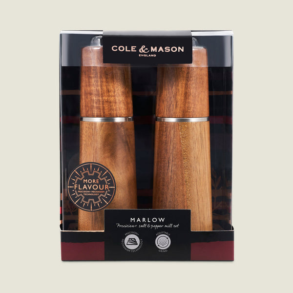 The Cole & Mason UK Marlow Natural Acacia Salt & Pepper Mills boxed set features a clear window showcasing the mills’ wood finish and branding, plus an adjustable grinder for precise seasoning.